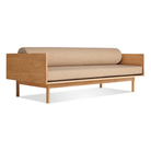 The Souvenir Sofa from Blu Dot with the irving copper stripe upholstery and white oak frame from an angle.
