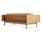 The Souvenir Sofa from Blu Dot with the irving copper stripe upholstery and white oak frame fromo the back at an angle.