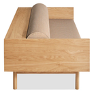 The Souvenir Sofa from Blu Dot with the irving copper stripe upholstery and white oak frame from the side at an angle.