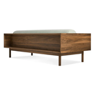 The Souvenir Sofa from Blu Dot with the irving gray blue stripe upholstery and walnut frame from the back at an angle.