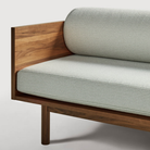 The Souvenir Sofa from Blu Dot with the irving gray blue stripe upholstery and walnut frame close up.