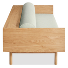 The Souvenir Sofa from Blu Dot with the irving gray blue stripe upholstery and white oak frame from the side at an angle.