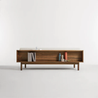 The Souvenir Sofa from Blu Dot with the landa stone upholstery and walnut frame from the back in a studio.