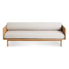 The Souvenir Sofa from Blu Dot with the landa stone upholstery and white oak frame from the front at an angle.