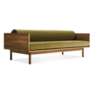 The Souvenir Sofa from Blu Dot with the loden green velvet upholstery and walnut frame from an angle.