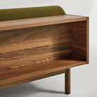 The Souvenir Sofa from Blu Dot with the loden green velvet upholstery and walnut frame showing the back in detail.