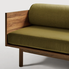 The Souvenir Sofa from Blu Dot with the loden green velvet upholstery and walnut frame close up.