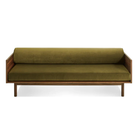 The Souvenir Sofa from Blu Dot with the loden green velvet upholstery and walnut frame from the front at an angle.