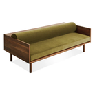 The Souvenir Sofa from Blu Dot with the loden green velvet upholstery and walnut frame from a high angle.