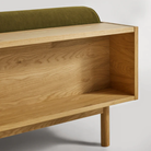 The Souvenir Sofa from Blu Dot with the loden green velvet upholstery and white oak frame showing the back in detail.