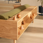 The Souvenir Sofa from Blu Dot with the loden green velvet upholstery and white oak frame in a family area.