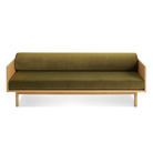 The Souvenir Sofa from Blu Dot with the loden green velvet upholstery and white oak frame from the front at an angle.