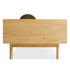 The Souvenir Sofa from Blu Dot with the loden green velvet upholstery and white oak frame from the side.