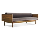 The Souvenir Sofa from Blu Dot with the storm velvet upholstery and walnut frame from an angle.
