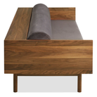 The Souvenir Sofa from Blu Dot with the storm velvet upholstery and walnut frame from the side at an angle.