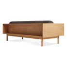 The Souvenir Sofa from Blu Dot with the storm velvet upholstery and white oak frame from the back at an angle.