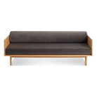 The Souvenir Sofa from Blu Dot with the storm velvet upholstery and white oak frame from the front at an angle.