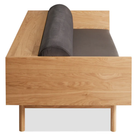 The Souvenir Sofa from Blu Dot with the storm velvet upholstery and white oak frame from the side at an angle.