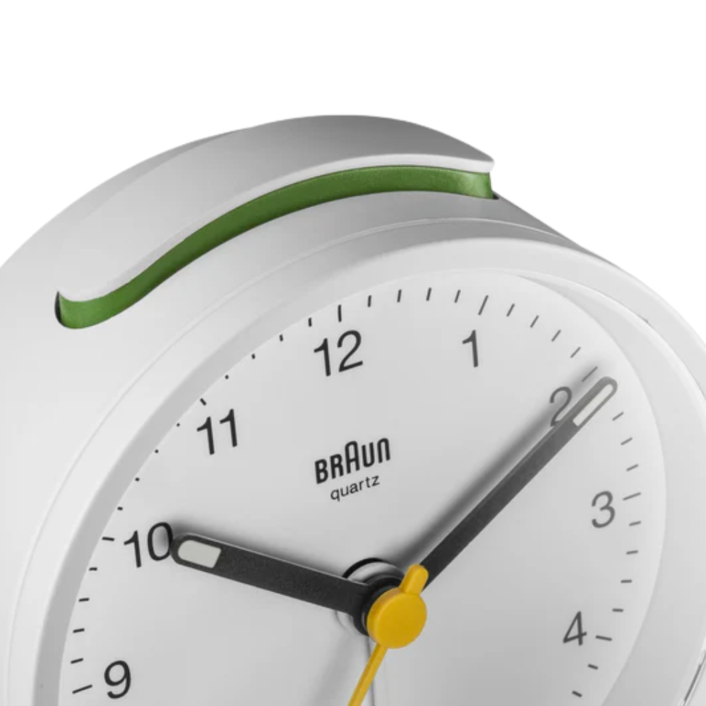 The white BC12 Round Alarm Clock by Braun from a top close-up.