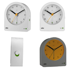 The white BC22 Alarm Clock from Braun with multiple views in a lifestyle image.