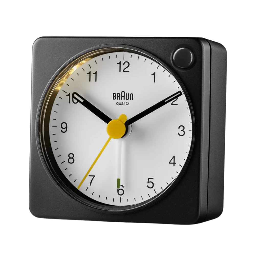The black and white BC2X Travel Alarm Clock by Braun from the side.