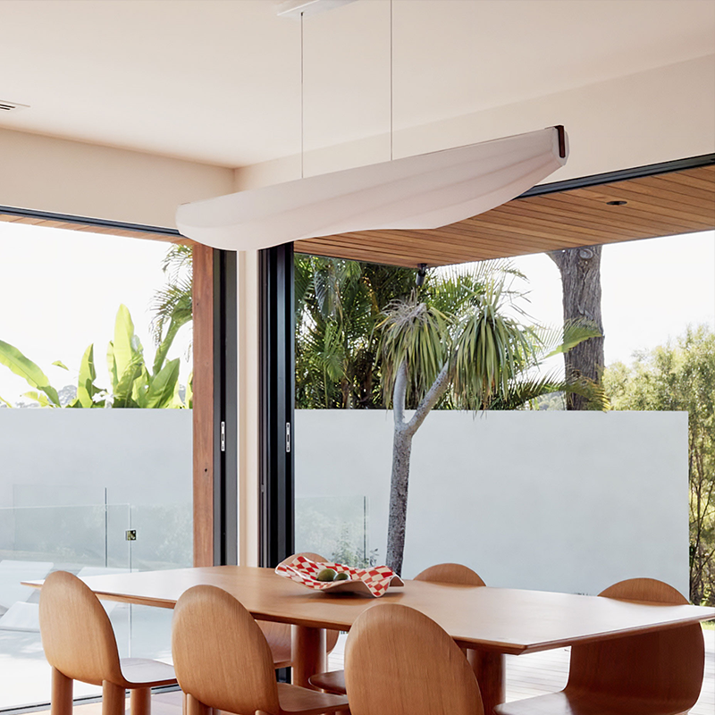 The Lenis Linear Pendant from Cerno in dark stained walnut in a kitchen.