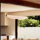 The Lenis Linear Pendant from Cerno in dark stained walnut in a dining room.