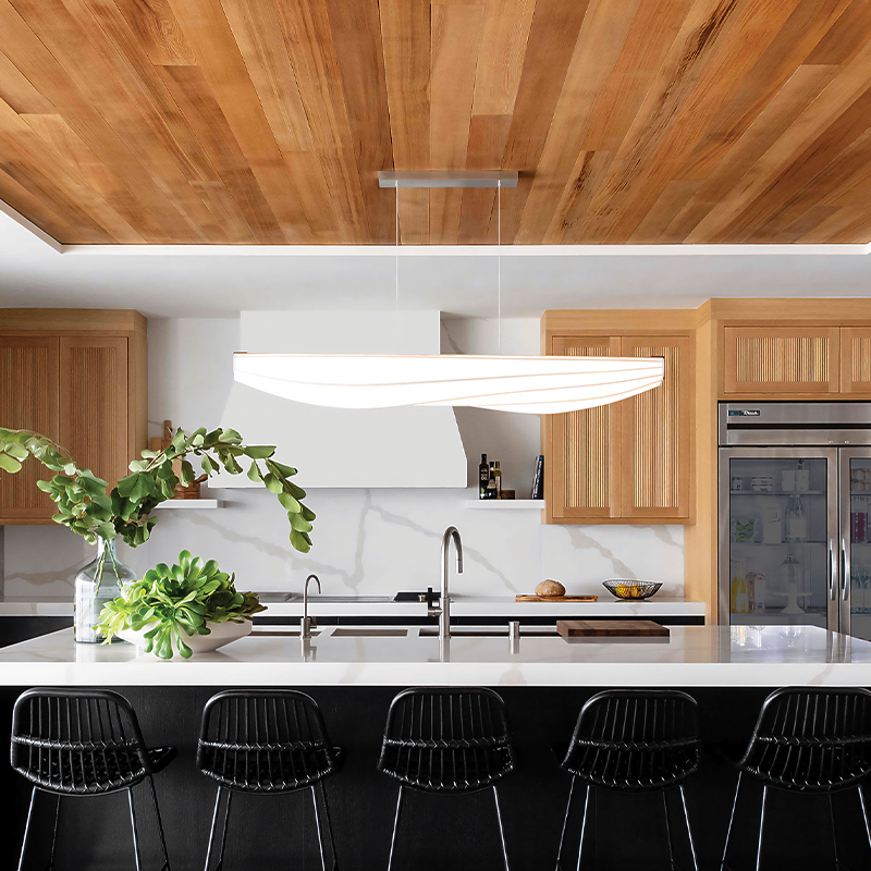 The Lenis Linear Pendant from Cerno in walnut in a kitchen.