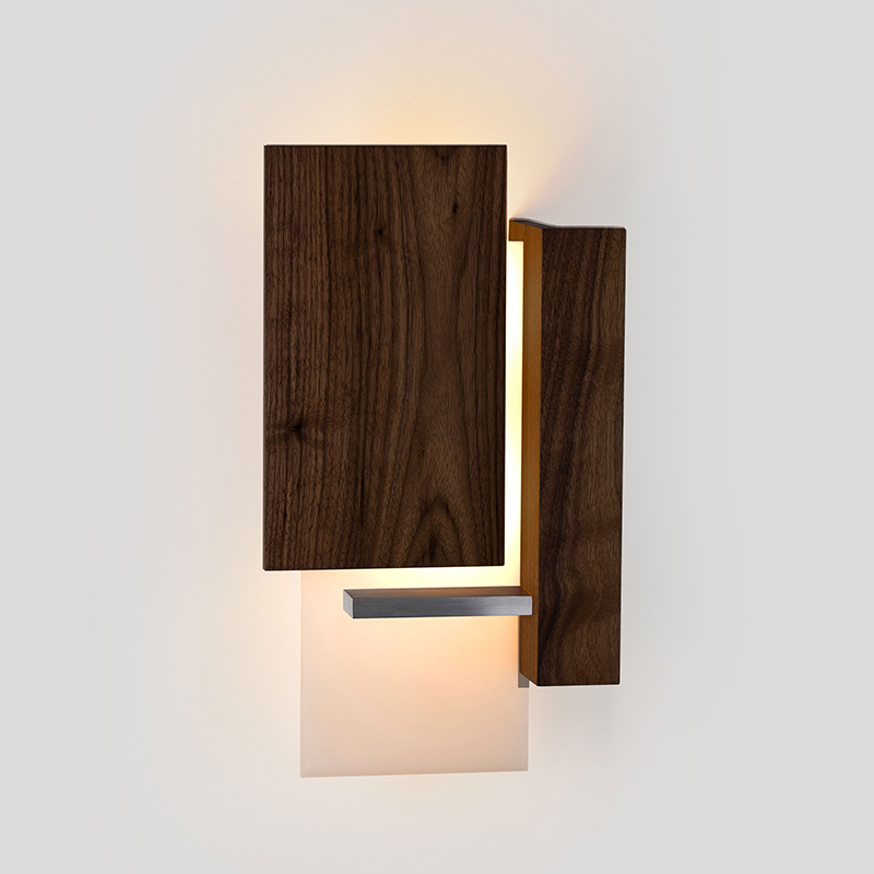 The Vesper Wall Sconce from Cerno in dark stained walnut in a living room.