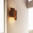 The Vesper Wall Sconce from Cerno in oiled walnut in a guest bedroom.