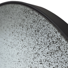 The Aged Wall Mirror Round clear from Ethnicraft with a close-up from the side.