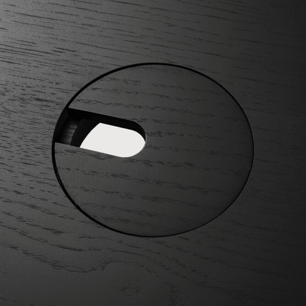 The Bok Adjustable Desk in black from Ethnicraft, with a close-up of the circular cutout.