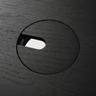 The Bok Adjustable Desk in black from Ethnicraft, with a close-up of the circular cutout.