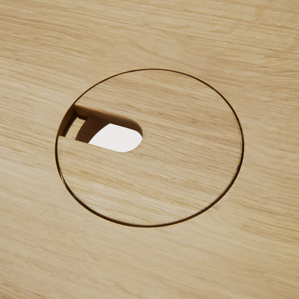 The Bok Adjustable Desk from Ethnicraft, with a close-up of the circular cutout.
