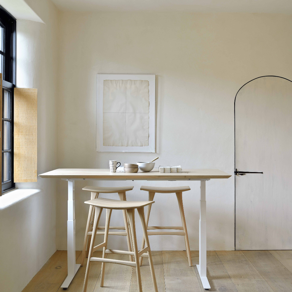 The Bok Adjustable Desk Oak from Ethnicraft in a dining area.
