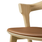 The Bok Upholstered Bar Stool by Ethnicraft focusing on the seat.