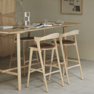 The Bok Upholstered Bar Stool by Ethnicraft in a living room.