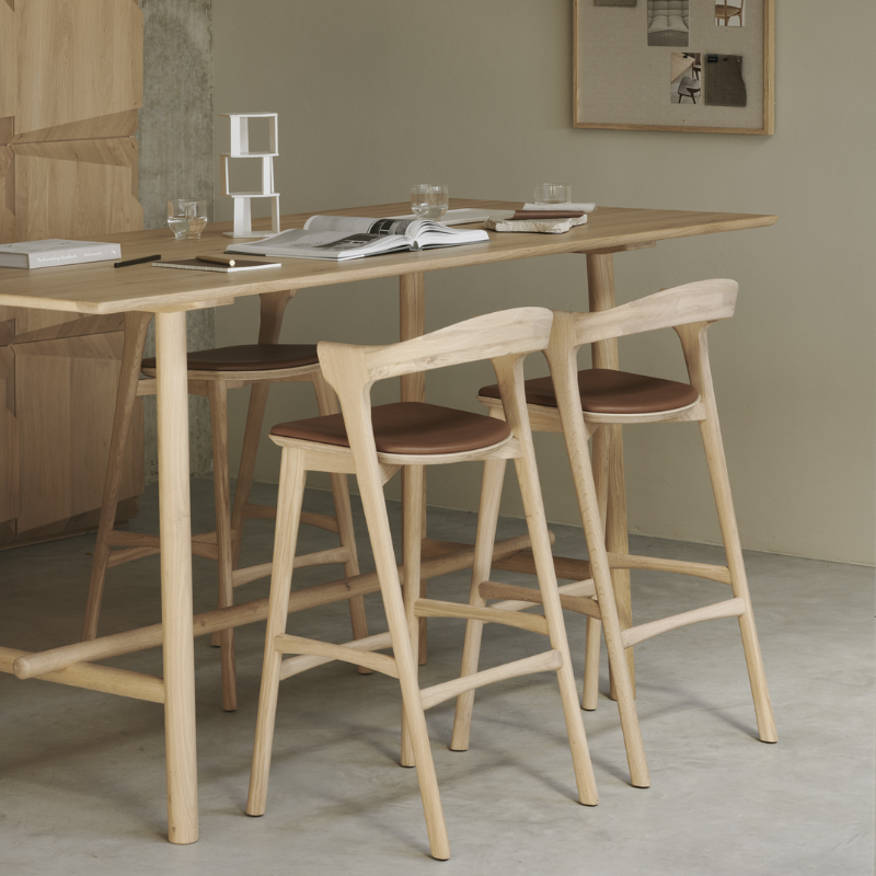 The Bok Upholstered Bar Stool by Ethnicraft in a living room.