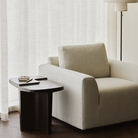 The Ease Lounge Chair by Ethnicraft in the living room with a side table.