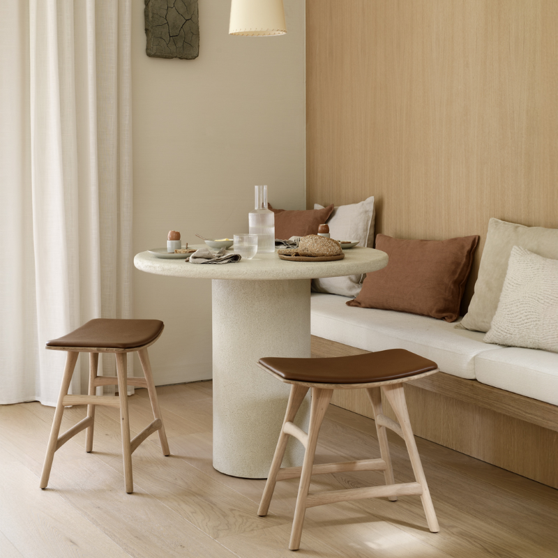 The 35.5-inch Elements Round Dining Table from Ethnicraft is in a living room.