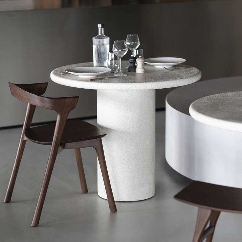 The 35.5-inch Elements Round Dining Table from Ethnicraft is used in a restaurant.