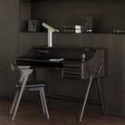 The Flow Desk by Ethnicraft in rose brown mahogany in a study room.