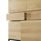 The Stairs Cupboard from Ethnicraft with the bottom close-up, with opened drawer and door.