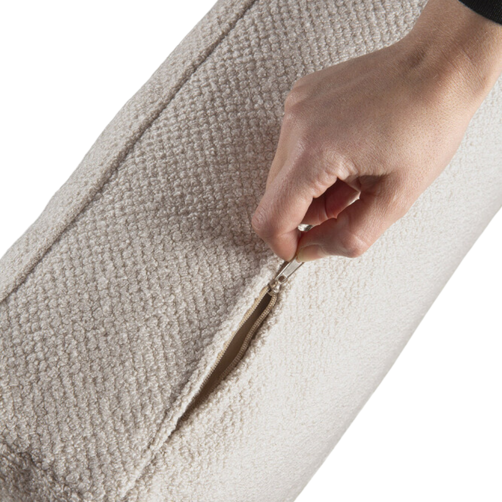 The Mellow Footstool Ivory from Ethnicraft, opens up the zip.