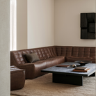 Ethnicraft's N701 3-seater Sofa in Chestnut leather in a living room.