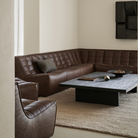 The N701 Leather Two Seater Sofa Chestnut from Ethnicraft in a living room.