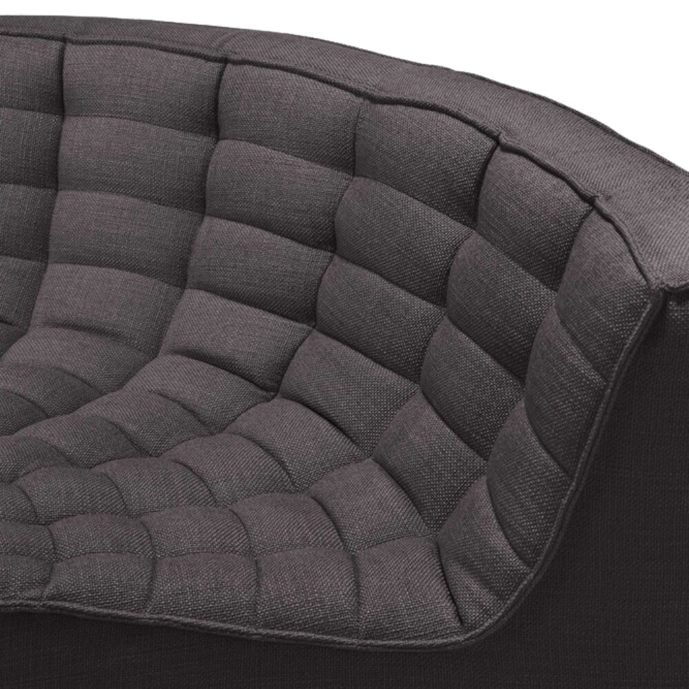 The N701 Modular Round Corner Sofa from Ethnicraft with dark gray standard fabric showing the curved corner close up.