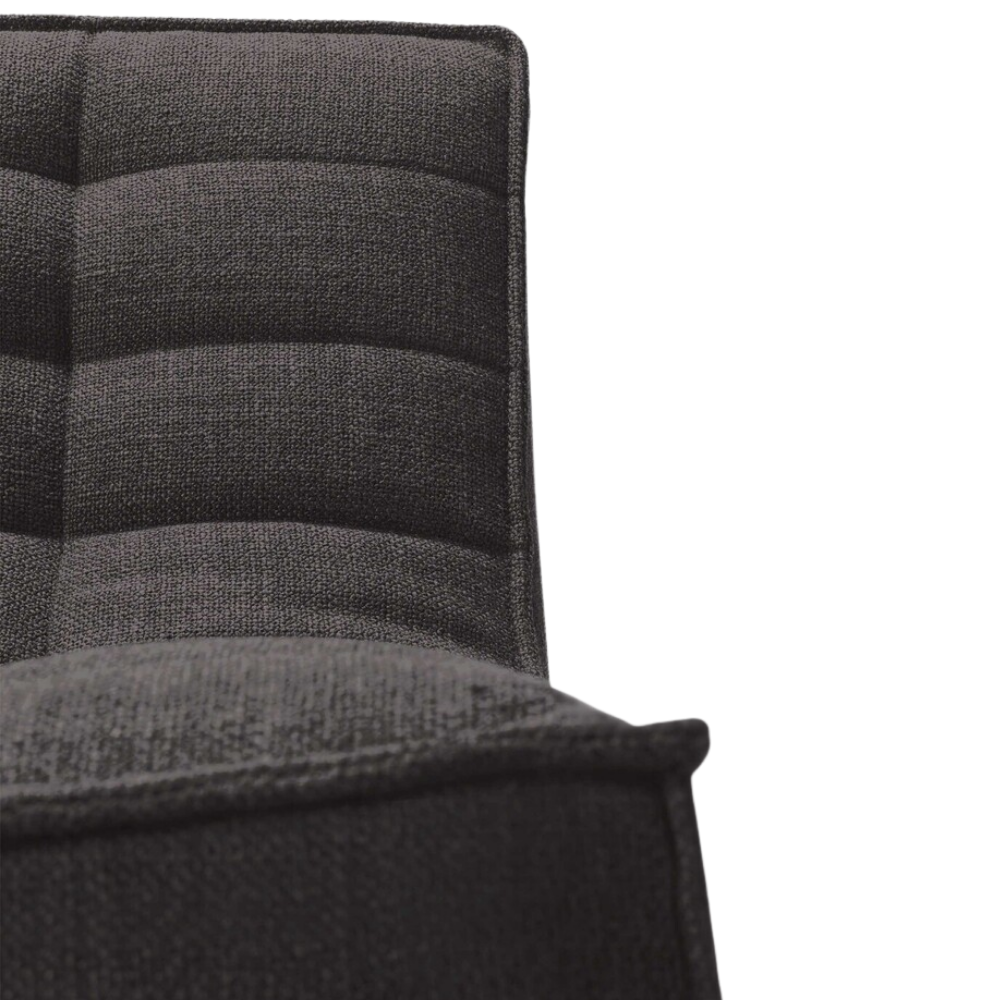 The N701 Modular Sofa from Ethnicraft with dark gray standard fabric highlighting the seat.