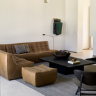 The N701 Modular Sofa from Ethnicraft with old saddle aniline leather in a den.
