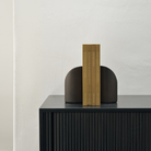 PI Book Ends in mahogany dark brown wood on a sideboard holding books.